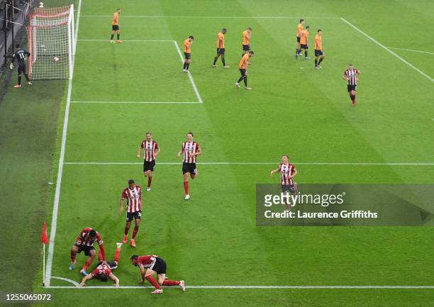 John Egan of Sheffield United celebrates with his team after he scores his sides first goal during the Premier League match between Sheffield United...