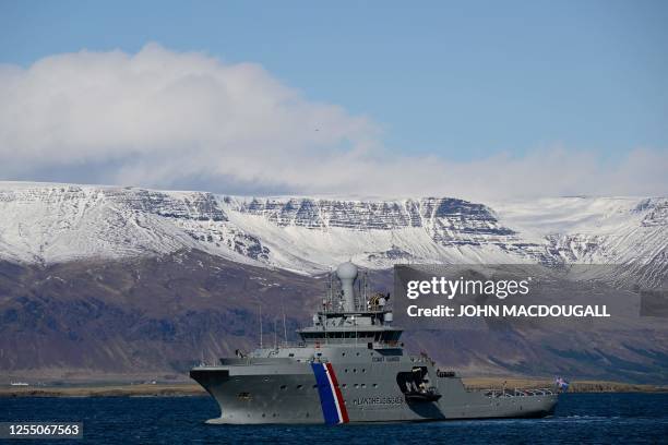 Picture taken on May 15, 2023 shows a ship of the Icelandic Coast Guard partols off the coast next to the Harpa Concert hall in Reykjavik, Iceland,...