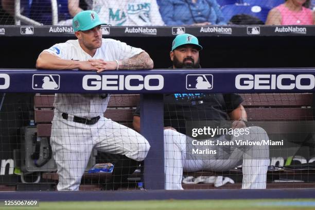 Skip Schumaker Manager of the Miami Marlins and Rod Barajas field coordinator watch the game against the Cincinnati Reds from the dugout at loanDepot...