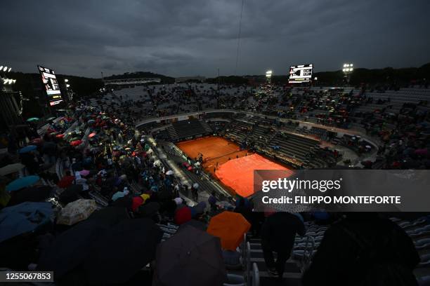 The Central Court is covered in tarp as the rain interrupts the third round of the Men's ATP Rome Open tennis tournament between Greece's Stefanos...