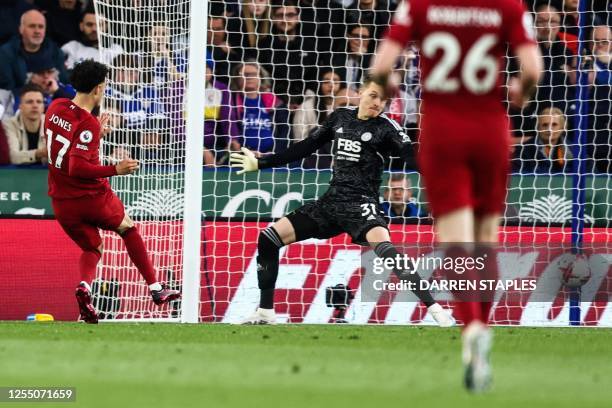 Liverpool's English midfielder Curtis Jones shoots and scores his team first goal during the English Premier League football match between Leicester...