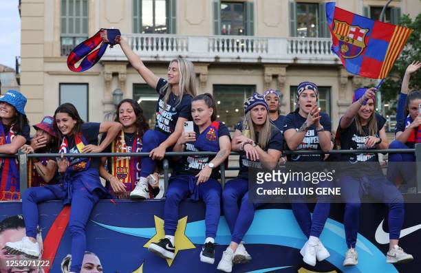 Barcelona's Spanish midfielder Alexia Putellas and the rest of players of FC Barcelona women football team, parade aboard a open-top bus preceded by...