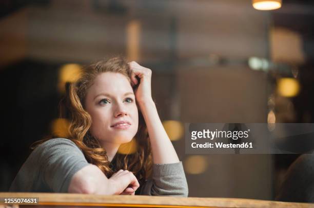 thoughtful woman leaning on table seen through glass window in coffee shop - day dreaming stock pictures, royalty-free photos & images