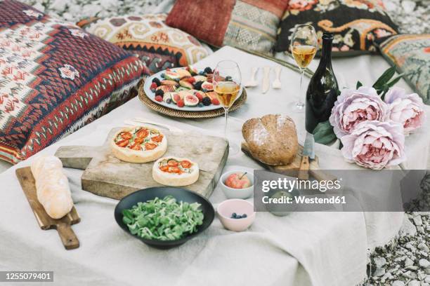 high angle view of various food with wine with flowers on table - fruit salad stock pictures, royalty-free photos & images