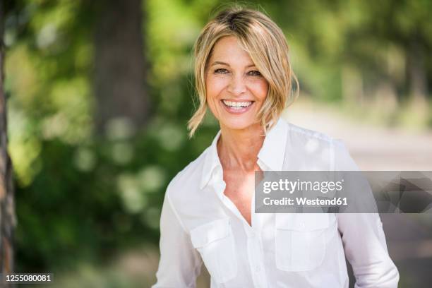 happy mature businesswoman standing outdoors - shirt pocket stock pictures, royalty-free photos & images