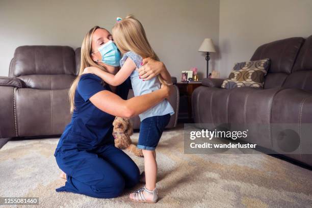 hugging mommy in her face mask - indiana home stock pictures, royalty-free photos & images