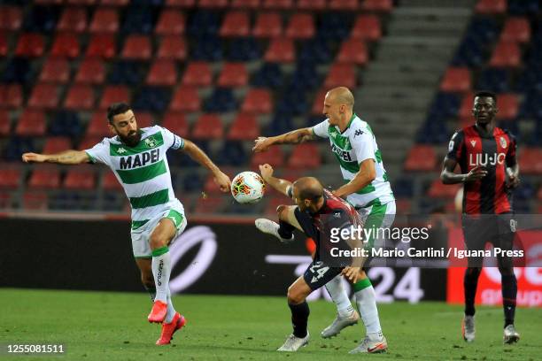 Rodrigo Palacio of Bologna FC competes for the ball with Francesco Magnanelli and Vlad Chiriches of Sassuolo during the Serie A match between Bologna...