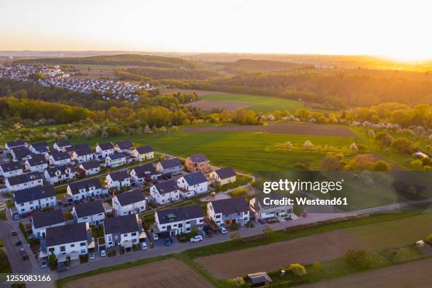 germany, baden-wurttemberg, waiblingen, aerial view of modern suburb at sunset - baden baden aerial fotografías e imágenes de stock