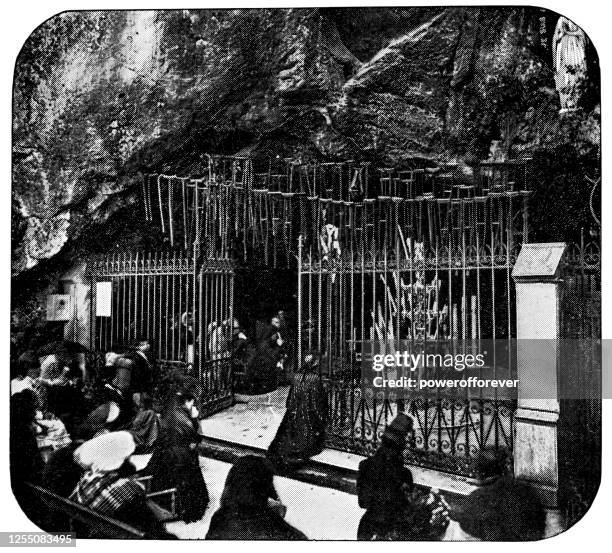 canes and crutches hang at the grotto of massabielle at the sanctuary of our lady of lourdes in lourdes, france - 19th century - bernadette soubirous stock illustrations