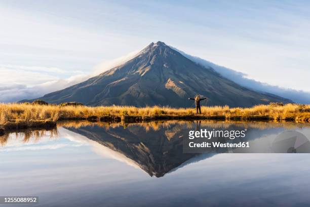 new zealand, mounttaranakivolcano reflecting in shiny lake at dawn - dormant volcano stock pictures, royalty-free photos & images