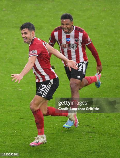 John Egan of Sheffield United celebrates with Lys Mousset after scoring the winning goal during the Premier League match between Sheffield United and...