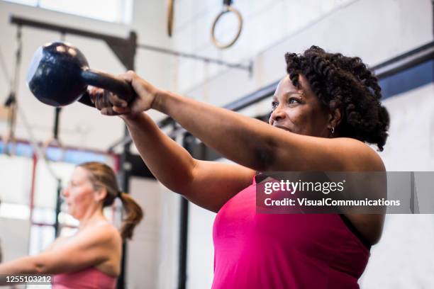 athlete exercising with kettlebell in the gym. - kettlebell imagens e fotografias de stock