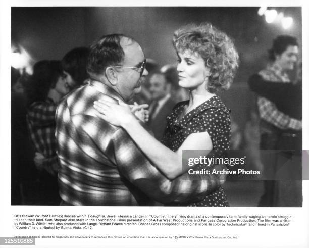 Wilford Brimley And Jessica Lange dance in a scene from the film 'Country', 1984.