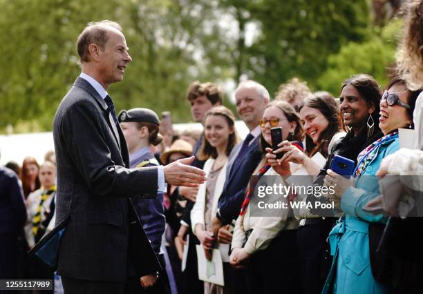 Prince Edward, Duke of Edinburgh talks to guests as he hosts young people from The Duke of Edinburgh's Award scheme in the garden of Buckingham...