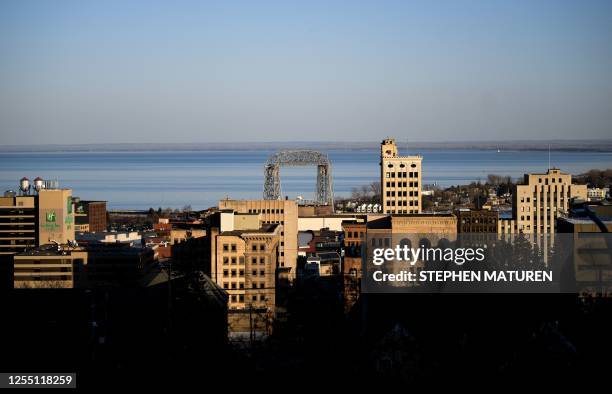 General view shows downtown and the Aerial Lift Bridge as the sun sets in Duluth, Minnesota, on April 12, 2023. In the far north of the United...