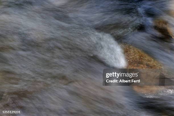 das fließen des wassers - fließen fotografías e imágenes de stock