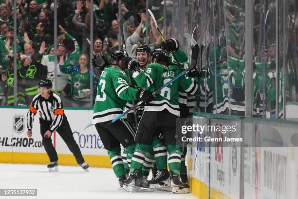 Jason Robertson, Esa Lindell and Colin Miller of the Dallas Stars celebrate a goal against the Seattle Kraken in Game Seven of the Second Round of...
