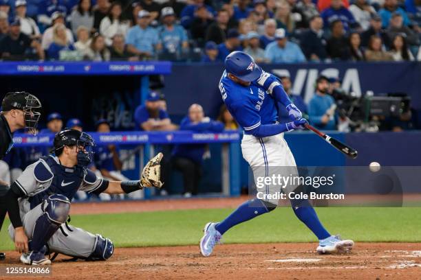 George Springer of the Toronto Blue Jays hits an RBI single in the eighth iinning of their MLB game against the New York Yankees at Rogers Centre on...