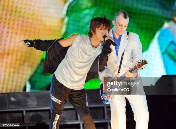 Kimura Takuya of Japanese boy band SMAP performs on the stage at Beijing Concert at Beijing Workers Stadium on September 16, 2011 in Bejing, China.