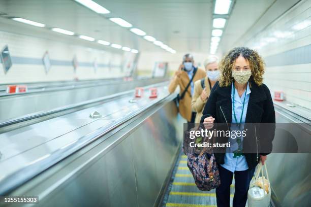 staying safe on the underground - covid commuter stock pictures, royalty-free photos & images