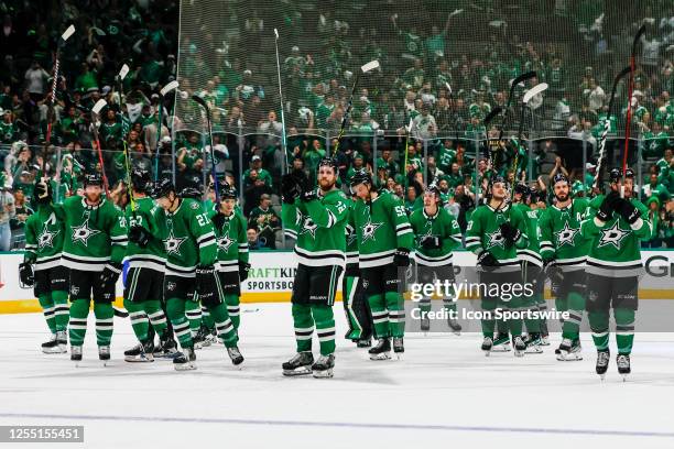 The Dallas Stars players raise their sticks to the fans after winning the Western Conference Second Round playoff game 7 between the Dallas Stars and...