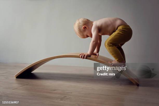 little boy climbing - baby climbing stock pictures, royalty-free photos & images