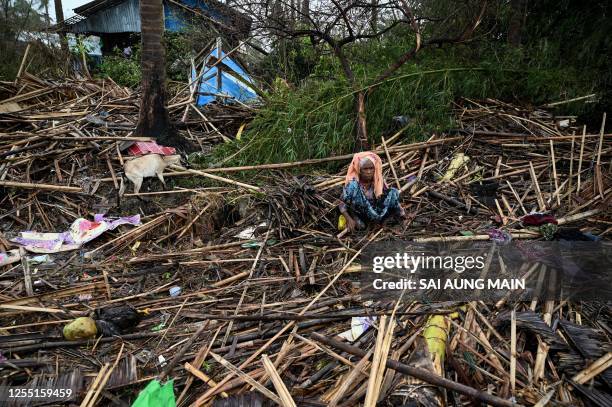 Rohingya woman sits in her destroyed house at Basara refugee camp in Sittwe on May 16 after cyclone Mocha made a landfall. The death toll in...