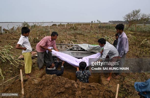 People carry the body of a victim during a funeral near Basara refugee camp in Sittwe, Rakhine State, on May 16 after cyclone Mocha made a landfall....