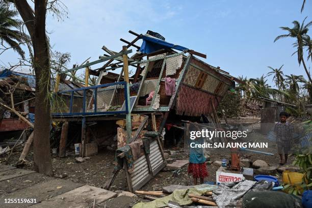 Girl draws water from a pump at Basara refugee camp in Sittwe on May 16 after cyclone Mocha made a landfall. The death toll in cyclone-hit Myanmar's...