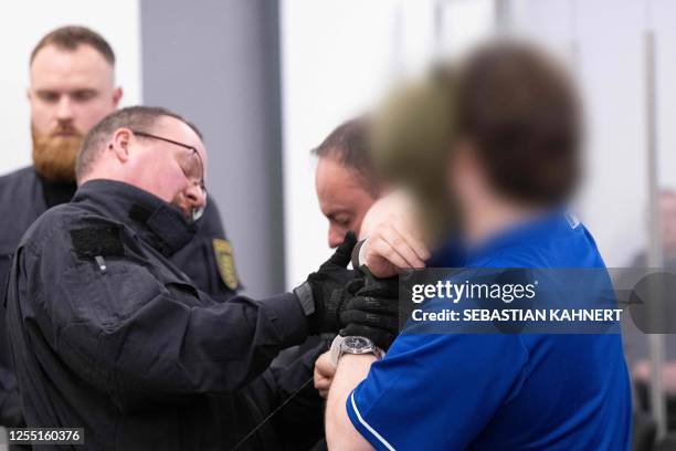 Defendant is brought to the courtroom on May 16, 2023 at the Higher Regional Court in Dresden, eastern Germany, prior to a hearing in the trial over...