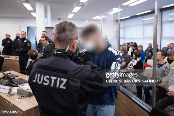 Defendant is brought to the courtroom on May 16, 2023 at the Higher Regional Court in Dresden, eastern Germany, prior to a hearing in the trial over...