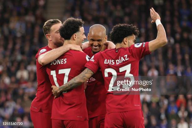 Curtis Jones of Liverpool celebrates with teammates Luis Diaz, Jordan Henderson and Fabinho after scoring the teams first goal during the Premier...