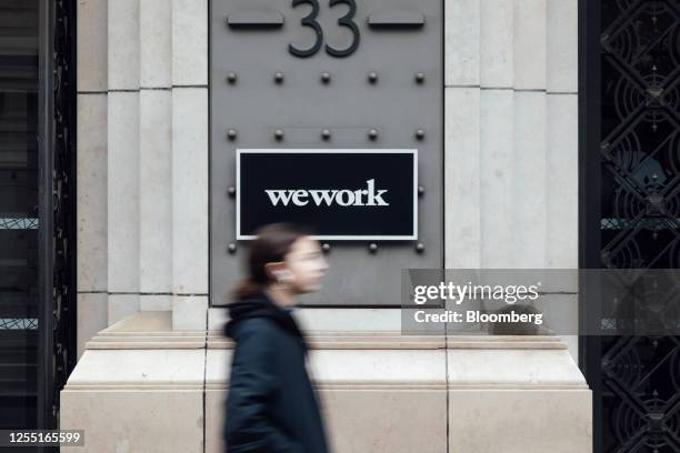 Sign for WeWork at the company's la Fayette co-working office space in Paris, France, on Thursday, Feb. 24, 2023. A growing number of startups are...