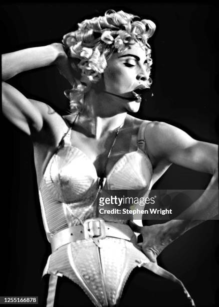 American singer-songwriter and actress Madonna performs on stage wearing cone brassiere by Jean-Paul Gaultier during the Blond Ambition World Tour,...
