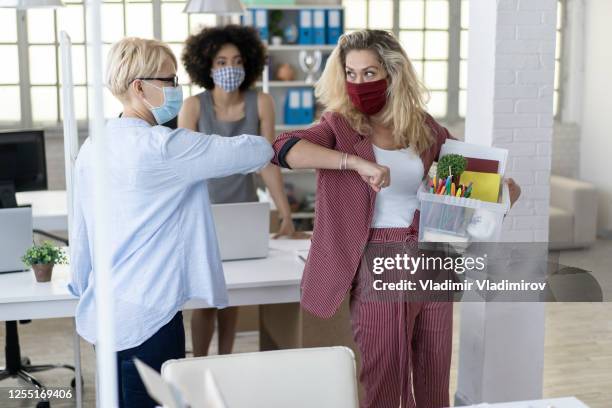 safety greeting manager and employee after firing - touching elbows stock pictures, royalty-free photos & images