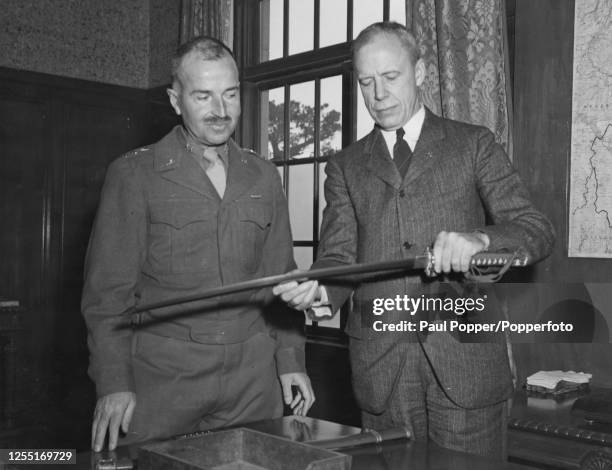 Major General William C Chase of the United States Army, Commander of the 1st Cavalry Division, presents a souvenir Japanese ceremonial sword to...