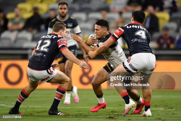 Valentine Holmes of the Cowboys is tackled during the round nine NRL match between the North Queensland Cowboys and the Sydney Roosters at QCB...