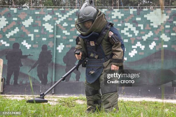 An exploder uses a deminer to detect a "minefield" during an explosive disposal training of People's Armed police in Nanning, South China's Guangxi...