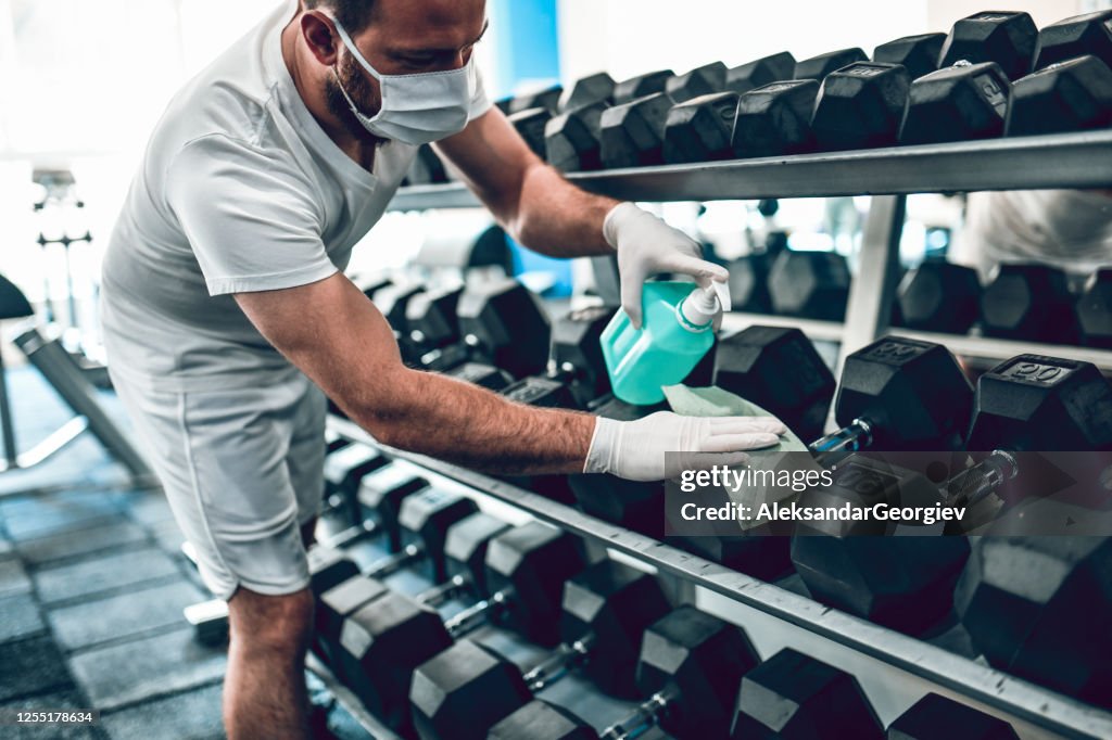 Gym Disinfection By Male With Face Mask