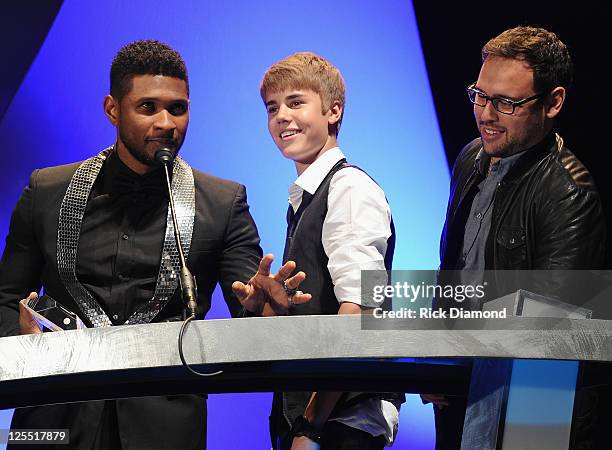 Singer/Songwriters Usher Raymond, Singer/Songwriter Justin Bieber and Bieber Mananger Scooter Braun present 2011 inducee Jan Smith at the 33rd Annual...