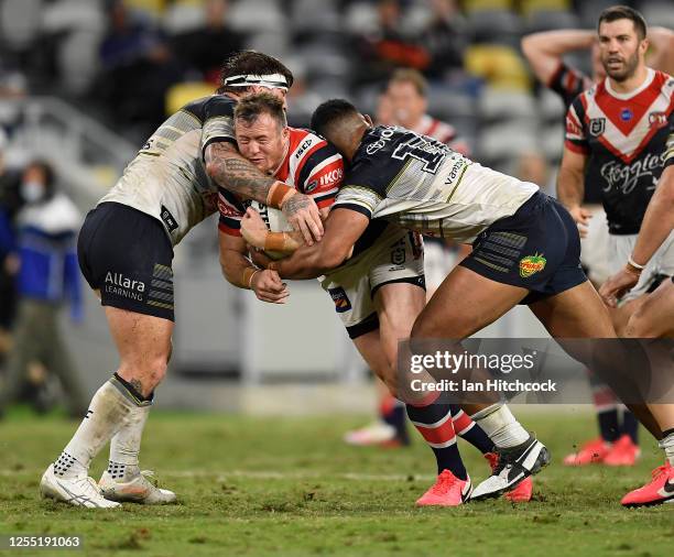 Josh Morris of the Roosters is tackled during the round nine NRL match between the North Queensland Cowboys and the Sydney Roosters at QCB Stadium on...