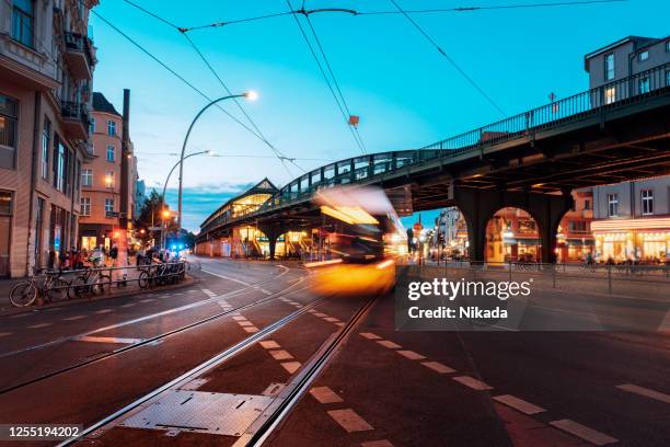 yellow passing tram in berlin, germany - prenzlauer berg stock pictures, royalty-free photos & images