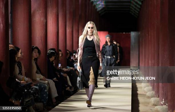 Models present a creation by Italian brand Gucci during the Gucci 2024 Cruise Collection Fashion Show at Gyeongbok-gung Palace in Seoul on May 16,...