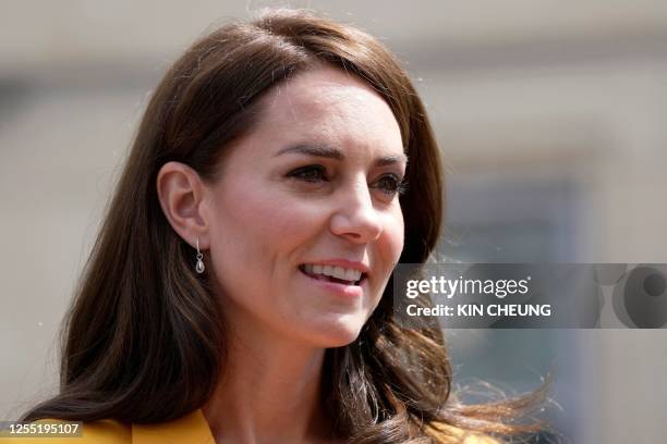 Britain's Catherine, Princess of Wales, reacts as she visits the Dame Kelly Holmes Trust in Bath, south west England on May 16 where she met with...