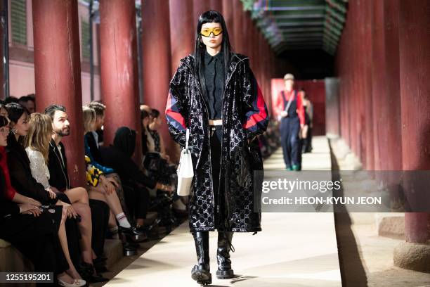 Models present a creation by Italian brand Gucci during the Gucci 2024 Cruise Collection Fashion Show at Gyeongbok-gung Palace in Seoul on May 16,...