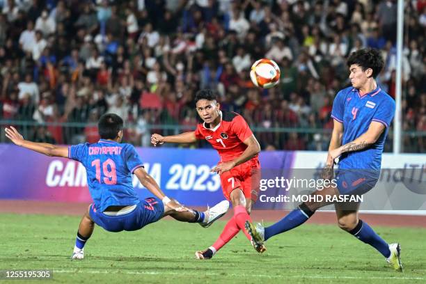 Indonesia's Marselino Ferdinan shoots past Thailand's Chayapipat Supunpasuch during the men's football final match at the 32nd Southeast Asian Games...