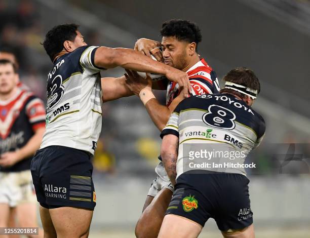 Poasa Faamausili of the Roosters is tackled by Jason Taumalolo and Josh McGuire of the Cowboys during the round nine NRL match between the North...