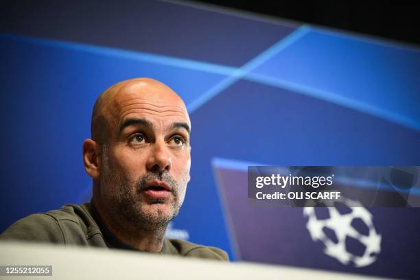 Manchester City's Spanish manager Pep Guardiola reacts as he speaks during a press conference at Manchester City training ground in Manchester,...