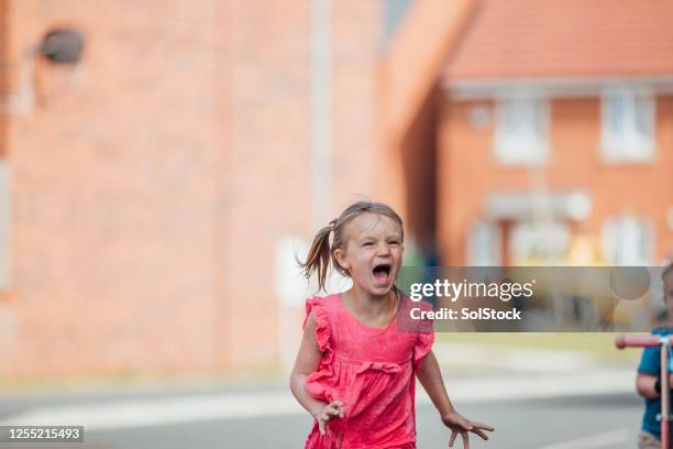 screaming in the street - fear stock pictures, royalty-free photos & images