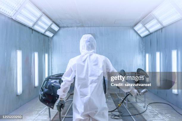 mechanic respraying a car in a garage - white suit stock pictures, royalty-free photos & images
